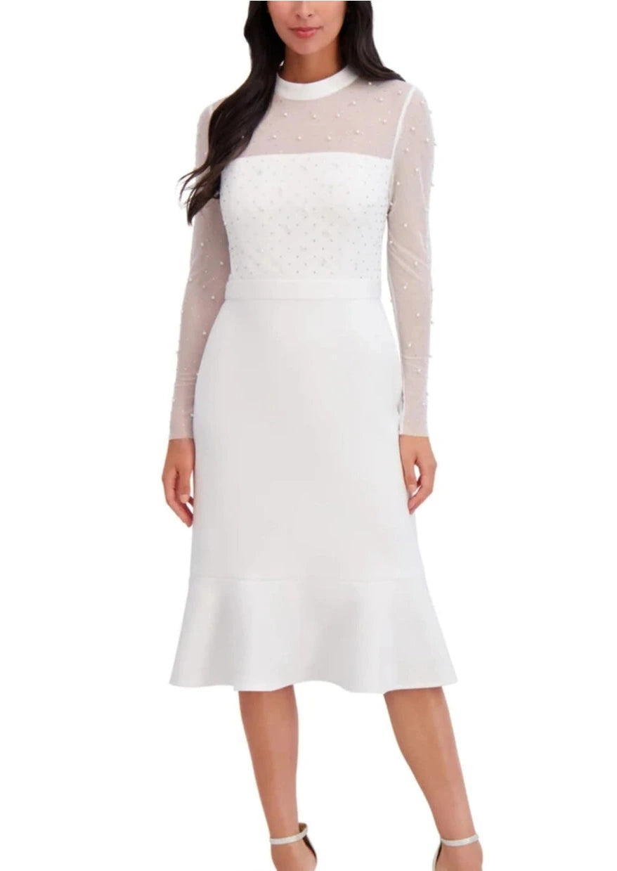 White dress with sheer sleeves worn by a model on a white background